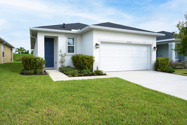 ranch-style home with a front lawn and a garage