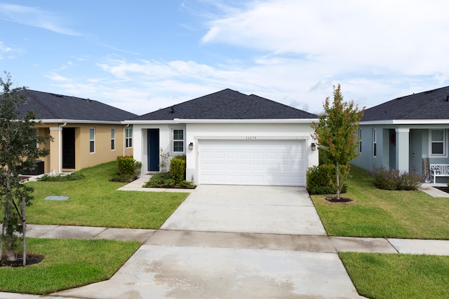 single story home featuring a front lawn and a garage