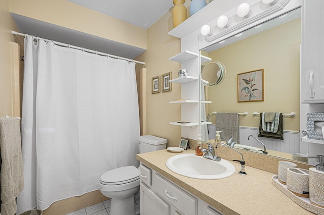 bathroom featuring vanity, toilet, a shower with shower curtain, and tile patterned floors