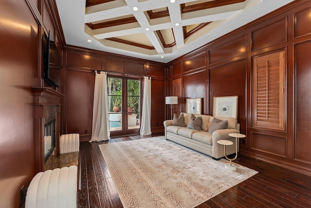 living room with coffered ceiling, dark hardwood / wood-style floors, beamed ceiling, and french doors