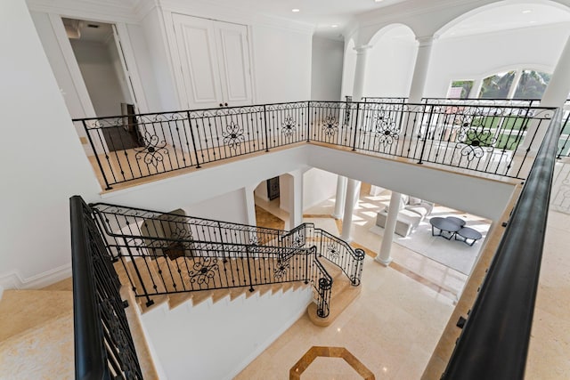 13058 Flamingo Ter, Palm Beach Gardens, FL 33410 - stairway featuring ornamental molding, recessed lighting, baseboards, arched walkways, and ornate columns