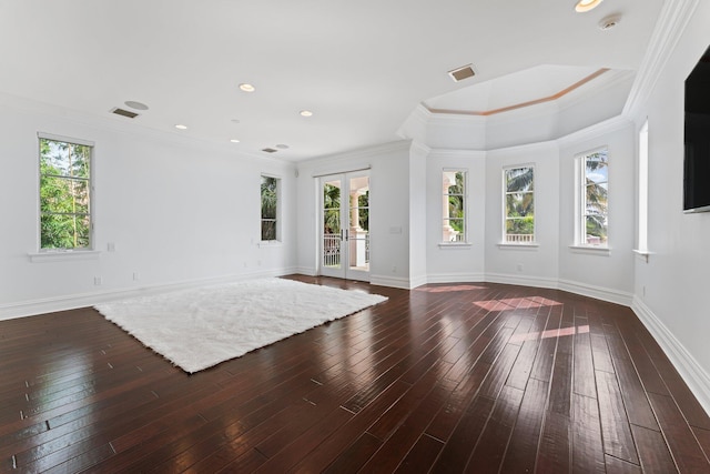 unfurnished living room with a wealth of natural light, crown molding, and french doors