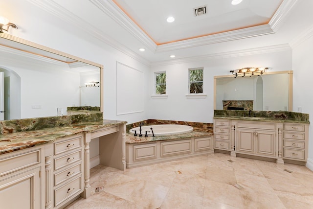 bathroom featuring vanity, ornamental molding, a bath, and a raised ceiling