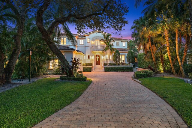 13058 Flamingo Ter, Palm Beach Gardens, FL 33410 - mediterranean / spanish house with a balcony, decorative driveway, stucco siding, and a yard