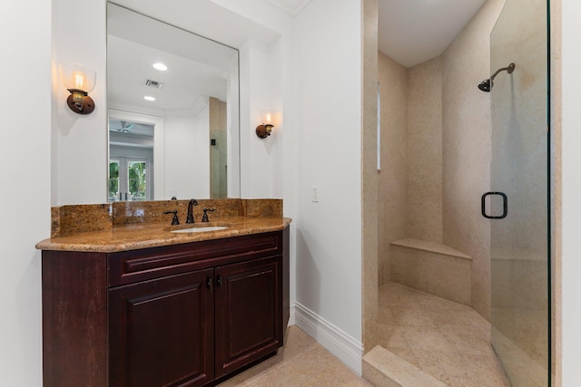 bathroom featuring tile patterned floors, walk in shower, and vanity