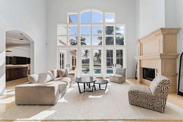 13058 Flamingo Ter, Palm Beach Gardens, FL 33410 - living area with a towering ceiling, a fireplace, and arched walkways