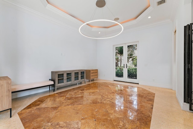 13058 Flamingo Ter, Palm Beach Gardens, FL 33410 - unfurnished dining area with a tray ceiling, crown molding, french doors, and baseboards