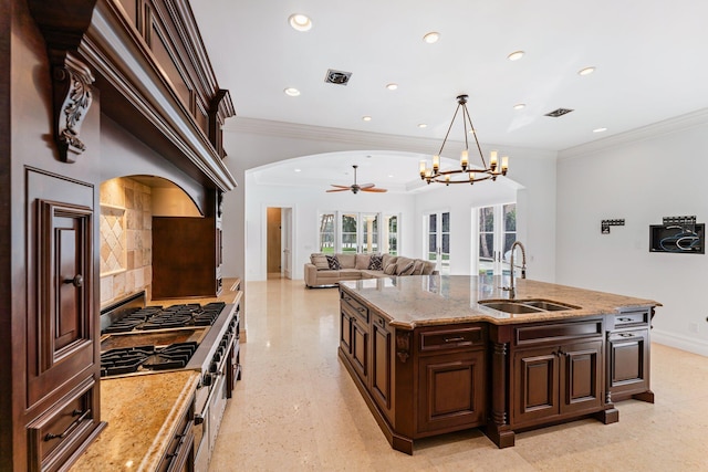 13058 Flamingo Ter, Palm Beach Gardens, FL 33410 - kitchen featuring a sink, crown molding, a chandelier, arched walkways, and recessed lighting