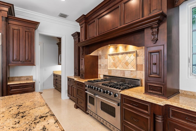 kitchen with dark brown cabinets, light stone counters, ornamental molding, and double oven range