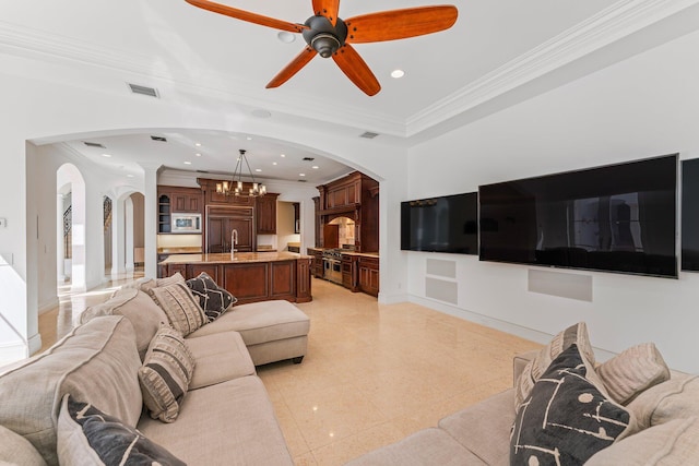 living room with ornamental molding, ornate columns, sink, and ceiling fan