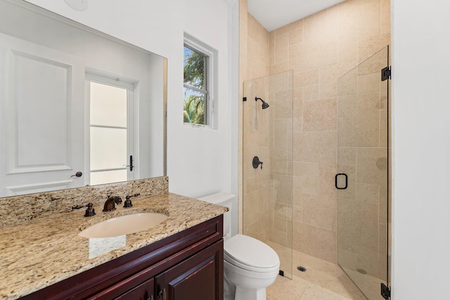 bathroom with walk in shower, toilet, and vanity