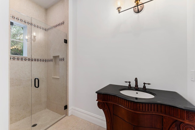 13058 Flamingo Ter, Palm Beach Gardens, FL 33410 - bathroom featuring a sink, a shower stall, baseboards, and tile patterned flooring