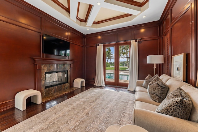 living room featuring coffered ceiling, a high end fireplace, crown molding, dark hardwood / wood-style flooring, and beam ceiling