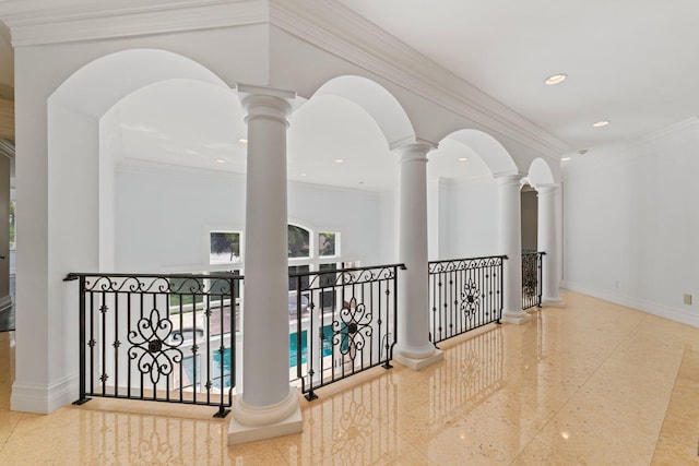 hall with crown molding and ornate columns