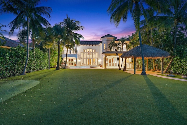 13058 Flamingo Ter, Palm Beach Gardens, FL 33410 - rear view of house featuring a gazebo, a balcony, a lawn, french doors, and stucco siding