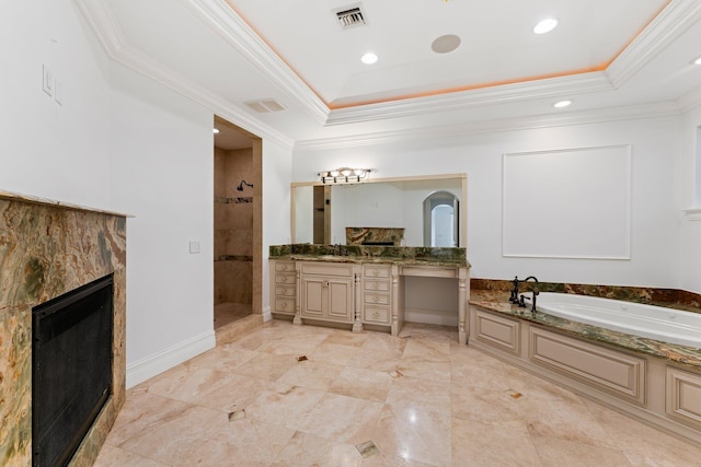 bathroom featuring separate shower and tub, a tile fireplace, ornamental molding, and vanity