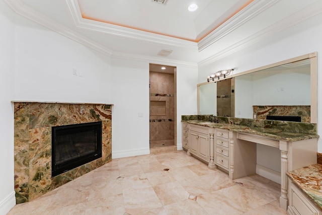 bathroom with a high end fireplace, vanity, ornamental molding, and tiled shower