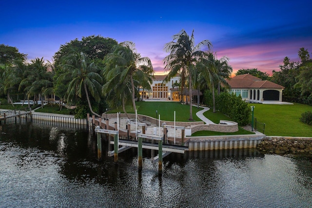 dock area featuring a yard and a water view