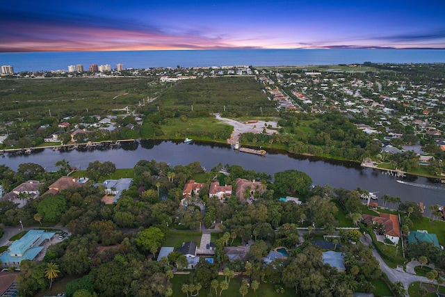 aerial view at dusk with a water view