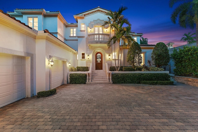 13058 Flamingo Ter, Palm Beach Gardens, FL 33410 - mediterranean / spanish house featuring a balcony, stucco siding, decorative driveway, and a tile roof