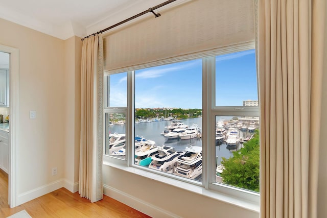 interior details with hardwood / wood-style floors and a water view