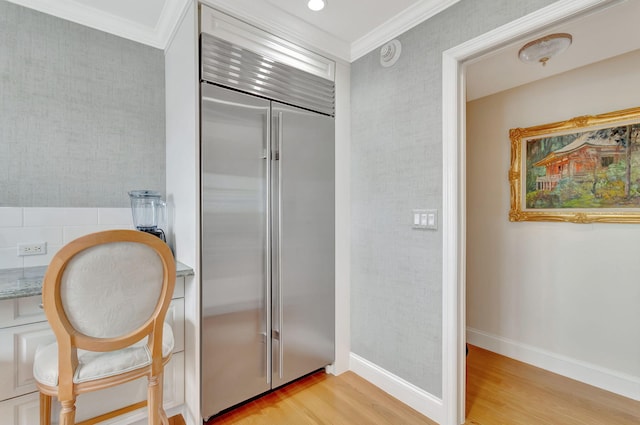 bathroom with wood-type flooring and crown molding