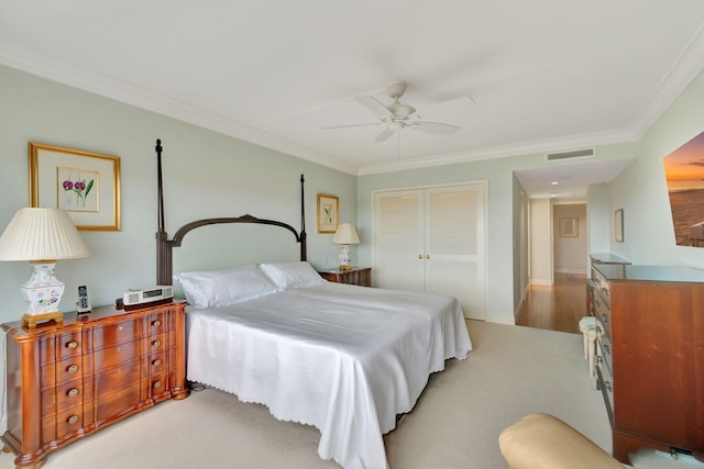 bedroom featuring ceiling fan, a closet, and ornamental molding