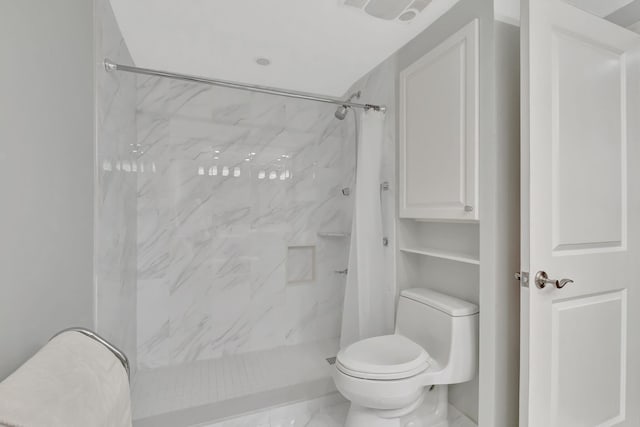 bathroom with a shower with curtain and toilet