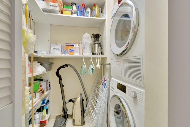 laundry area featuring stacked washer / drying machine