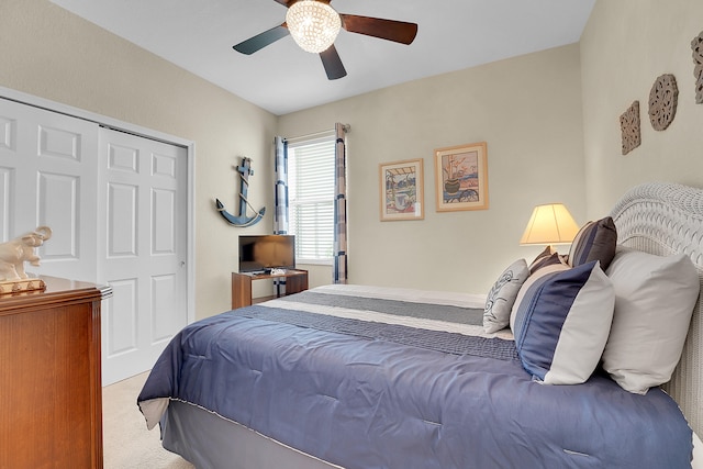 carpeted bedroom featuring a closet and ceiling fan