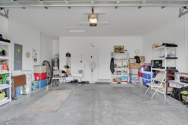 garage featuring electric panel, electric water heater, and a garage door opener