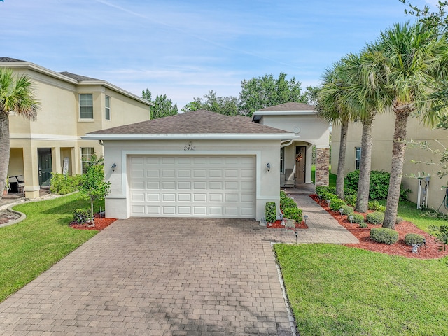 view of front of house with a front yard and a garage