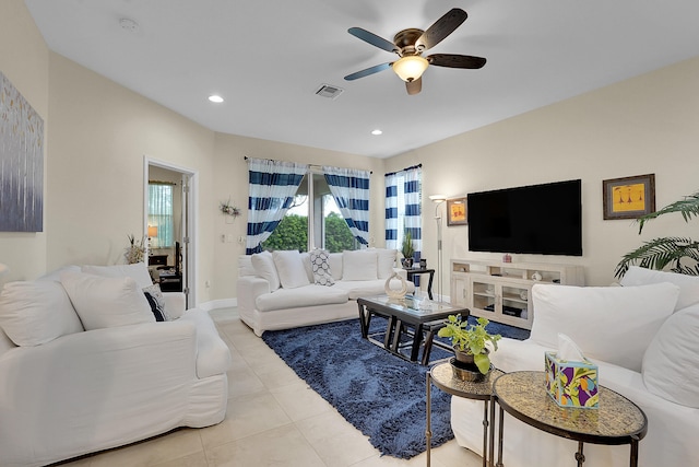 living room with ceiling fan and light tile patterned flooring