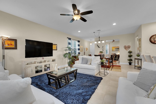 living room featuring ceiling fan and light tile patterned floors