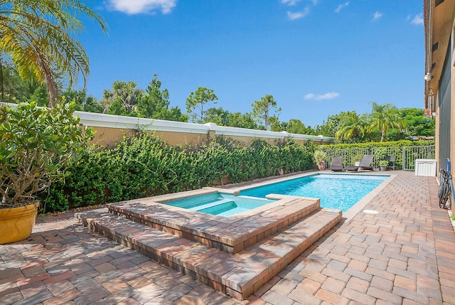 view of swimming pool with a patio area and an in ground hot tub