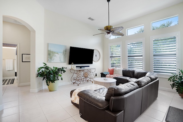 tiled living room with ceiling fan