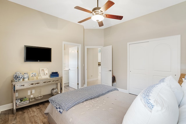 bedroom featuring ensuite bath, ceiling fan, a closet, and wood-type flooring