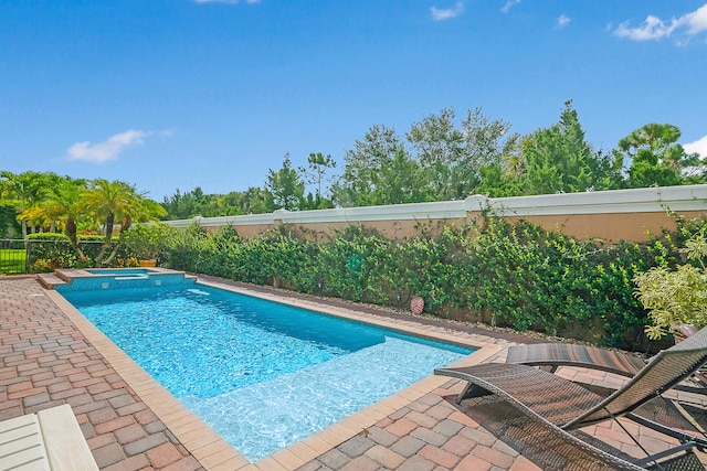 view of pool featuring an in ground hot tub