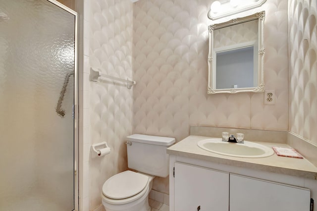 bathroom with vanity, toilet, and an enclosed shower