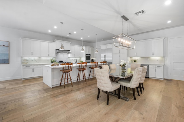 200 NE 6th Ct, Boca Raton, FL 33432 - dining room with light wood-type flooring, recessed lighting, a chandelier, and baseboards
