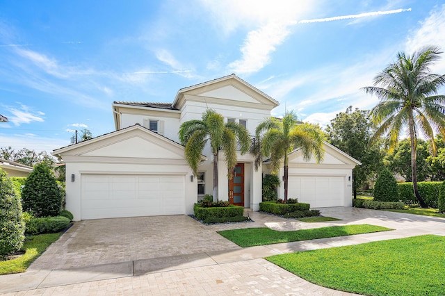 200 NE 6th Ct, Boca Raton, FL 33432 - view of front of home with decorative driveway, stucco siding, a garage, and a tiled roof