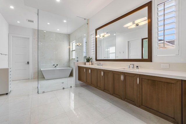 200 NE 6th Ct, Boca Raton, FL 33432 - bathroom with double vanity, a freestanding bath, recessed lighting, and tile patterned floors