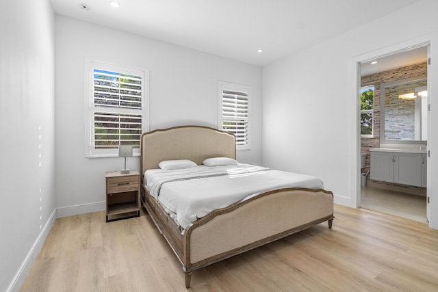 200 NE 6th Ct, Boca Raton, FL 33432 - bedroom with light wood-type flooring, baseboards, recessed lighting, and ensuite bath