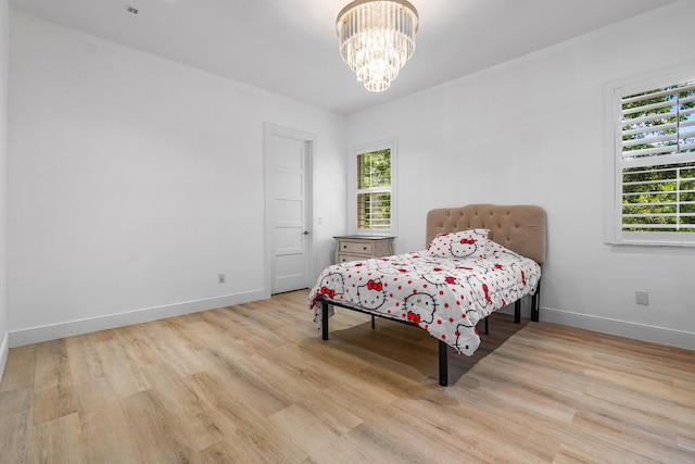 200 NE 6th Ct, Boca Raton, FL 33432 - bedroom featuring wood finished floors, multiple windows, and baseboards