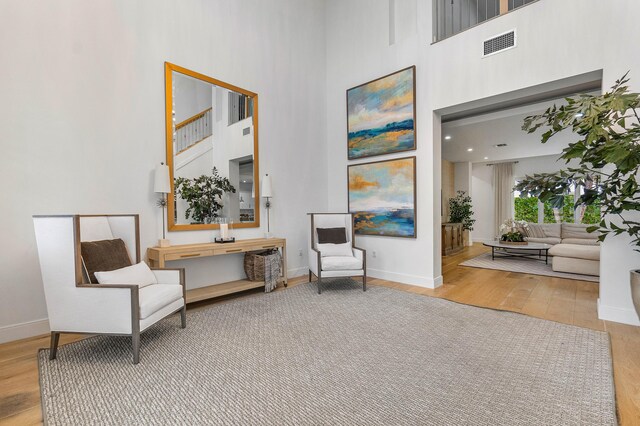 200 NE 6th Ct, Boca Raton, FL 33432 - living area featuring a towering ceiling, wood finished floors, and baseboards