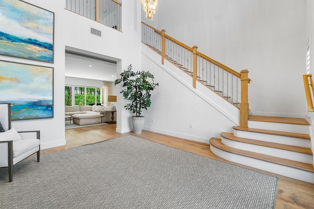 200 NE 6th Ct, Boca Raton, FL 33432 - stairway with wood finished floors, baseboards, and a high ceiling