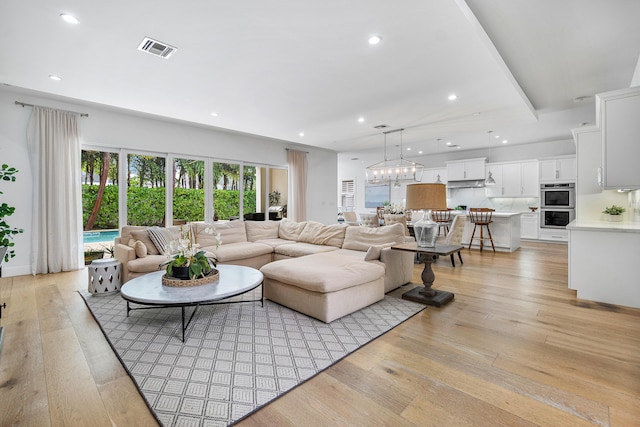 200 NE 6th Ct, Boca Raton, FL 33432 - living area featuring light wood finished floors, recessed lighting, and a chandelier