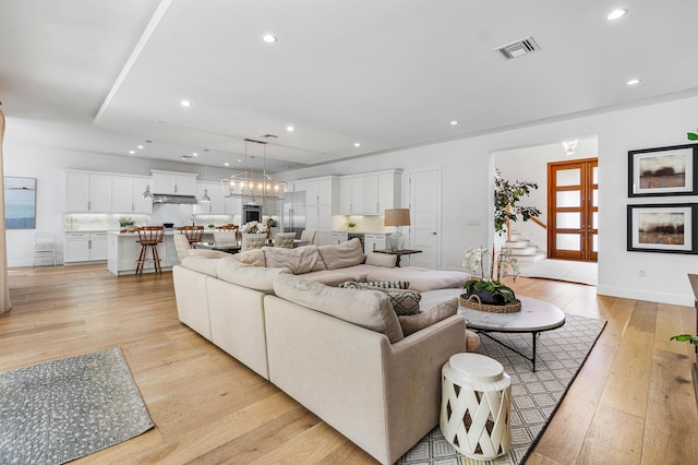 200 NE 6th Ct, Boca Raton, FL 33432 - living room featuring light wood-style floors, recessed lighting, and baseboards