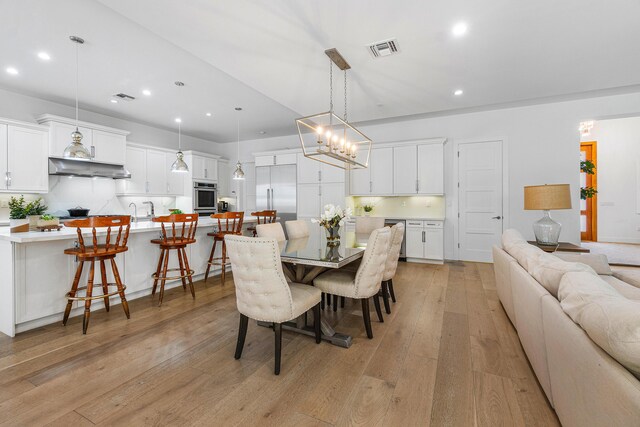 200 NE 6th Ct, Boca Raton, FL 33432 - dining space featuring recessed lighting, light wood-style floors, and a chandelier