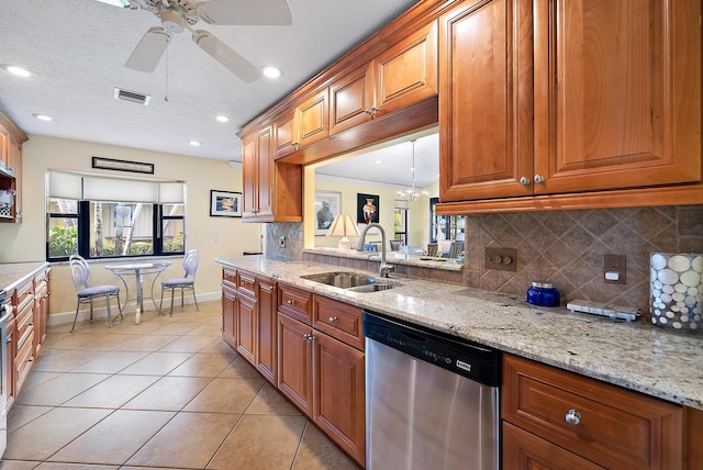 kitchen with dishwasher, ceiling fan with notable chandelier, light stone counters, and sink